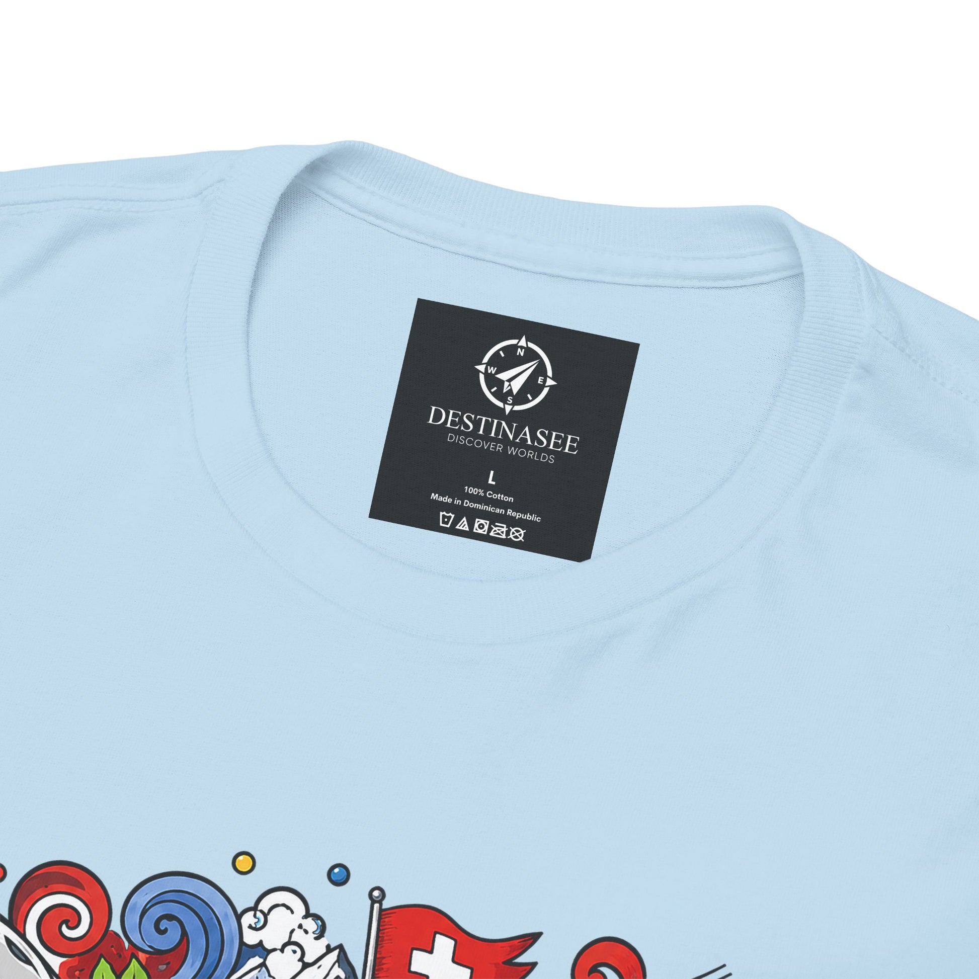 Light blue crewneck T-shirt with neck label and partial colorful graphic print.