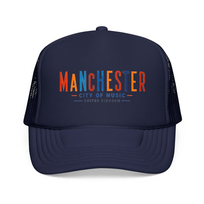 Dark navy trucker hat with mesh sides and curved brim; Manchester City of Music logo in orange/blue.