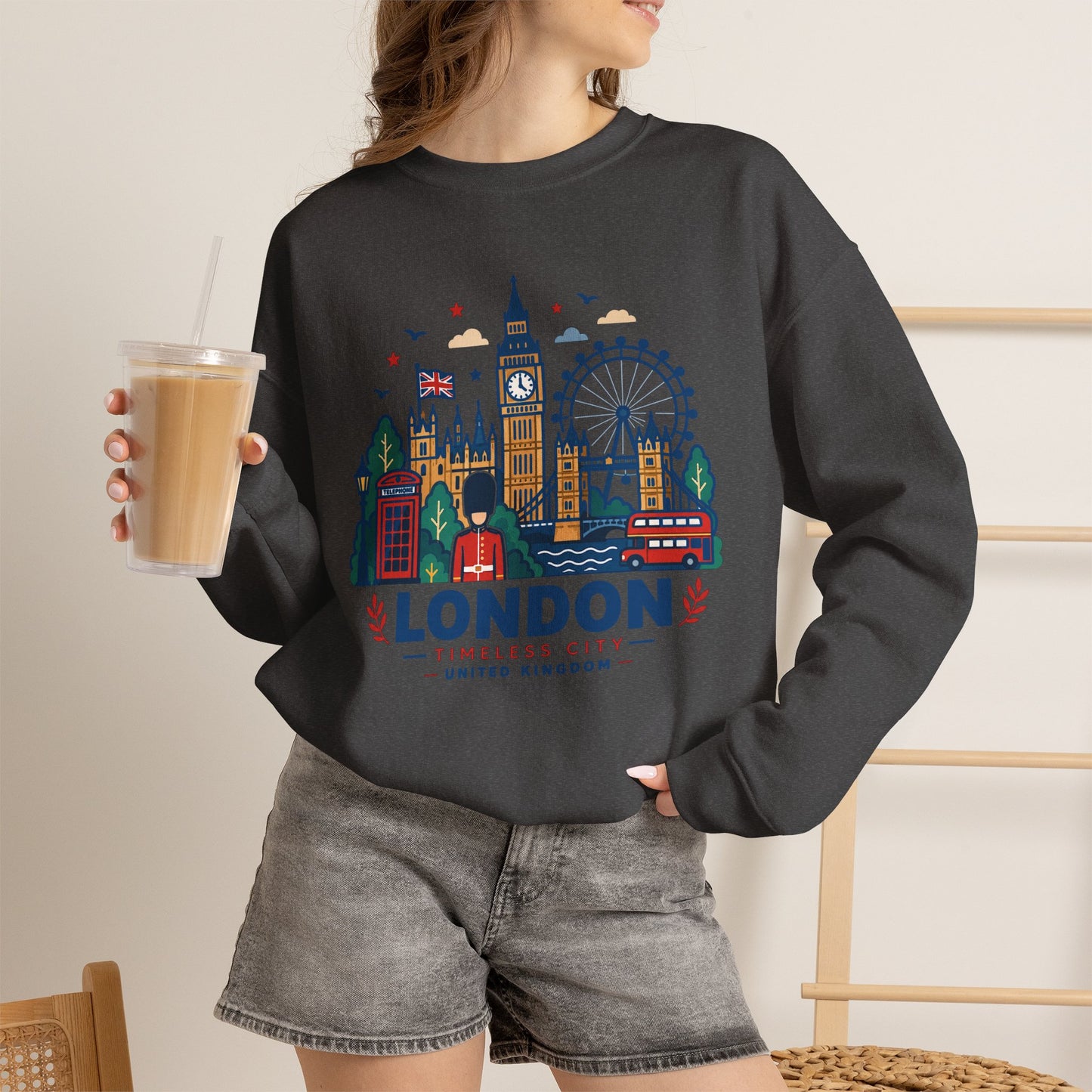 Black crewneck sweatshirt with colorful London skyline graphic and “London” logo