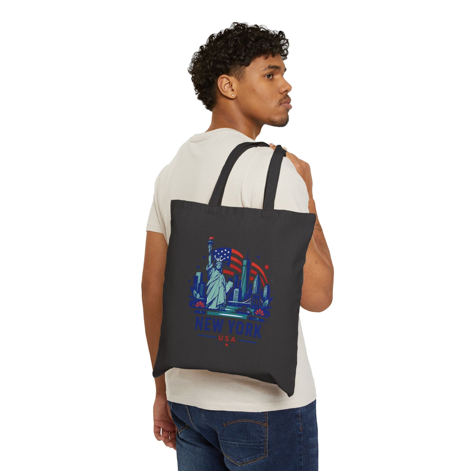 Black cotton canvas tote bag worn on back, featuring Statue of Liberty New York graphic