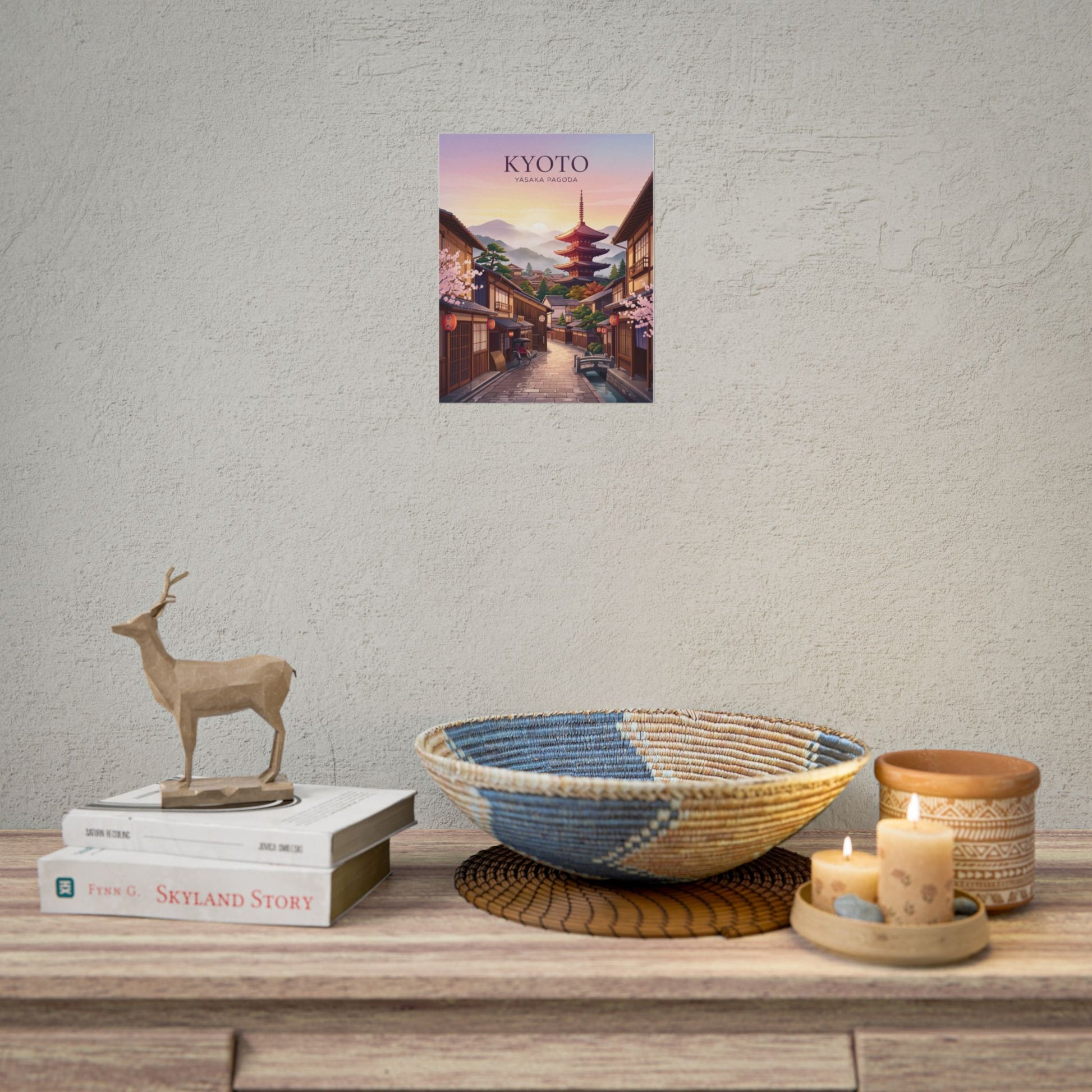 Rolled poster displayed on wall above shelf: Kyoto street with Yasaka Pagoda, title text included.