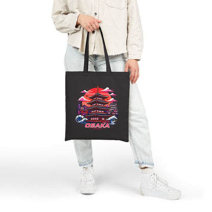 Black cotton tote bag with Osaka graphic hanging at the side on a person