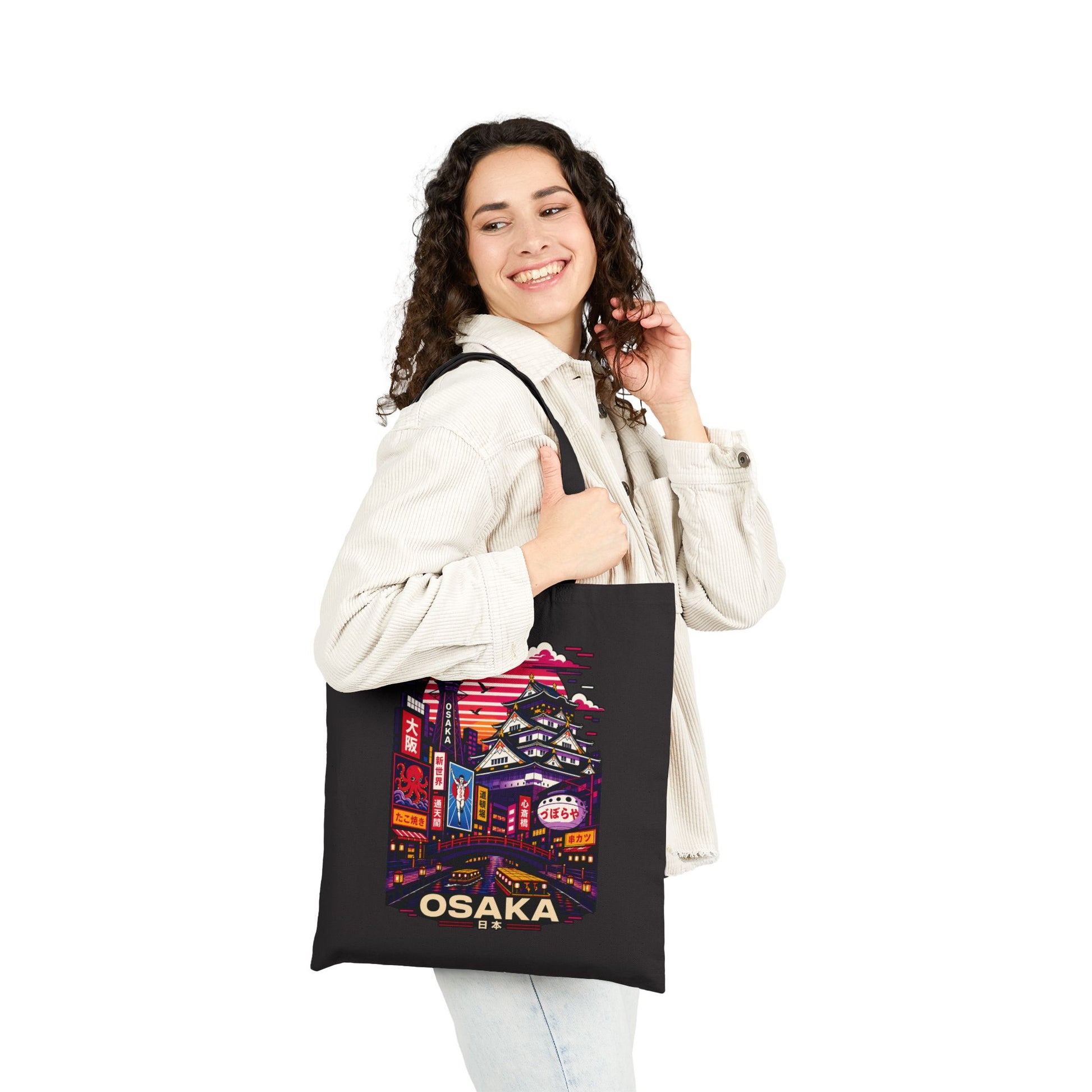 Black tote bag with Osaka skyline graphic, carried by a person with casual outfit