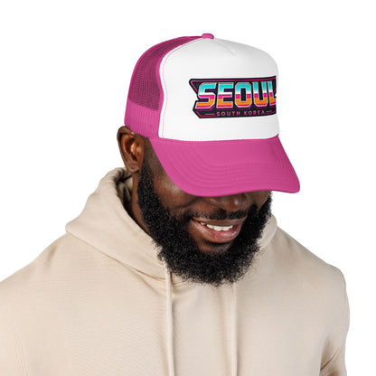 White and magenta trucker hat worn by model; “SEOUL SOUTH KOREA” patch logo