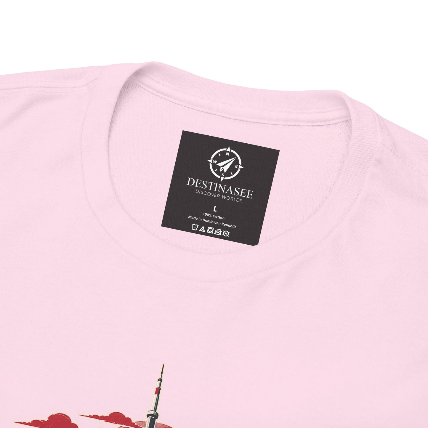 Pink crewneck T-shirt close-up of black neck label and partial Canada skyline graphic