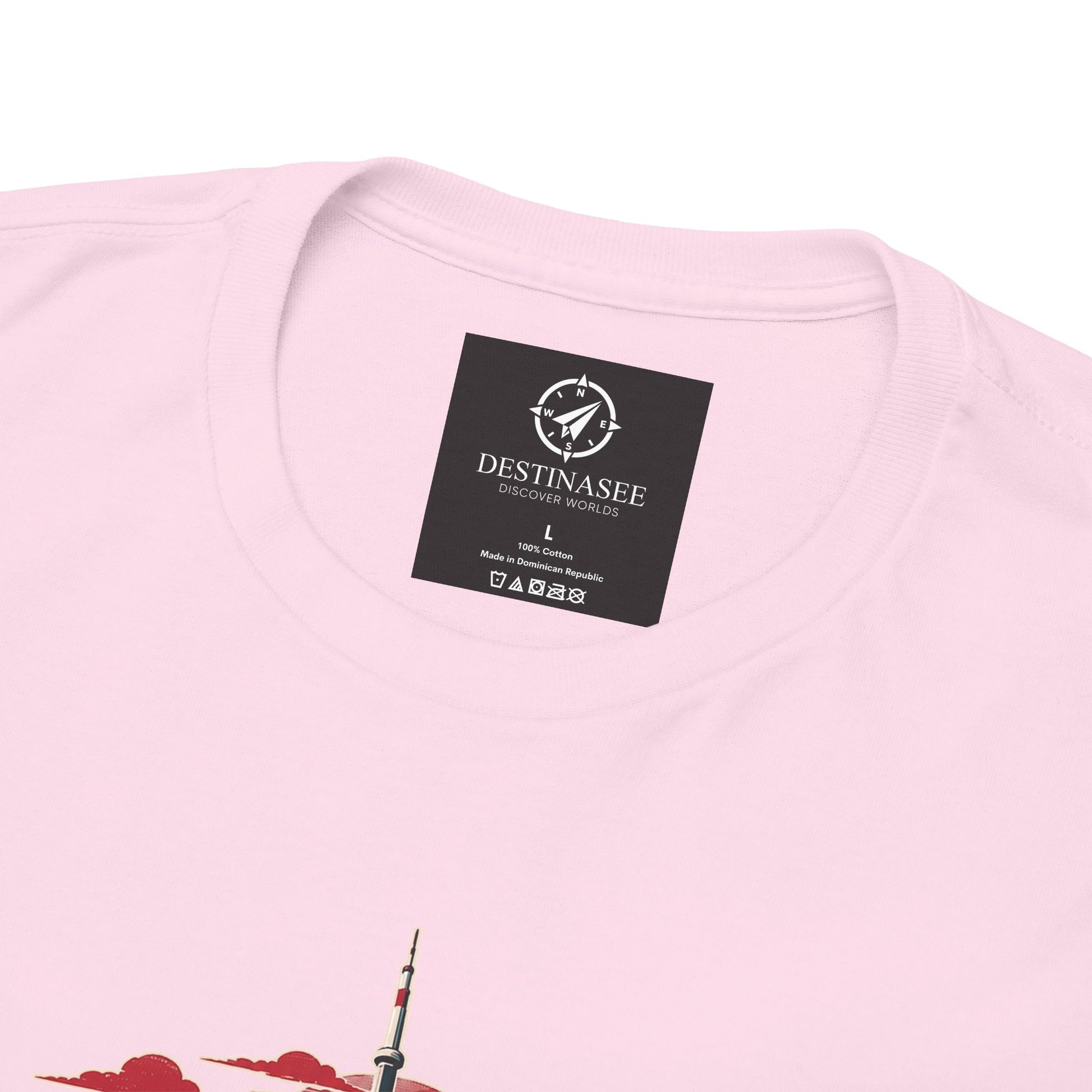 Pink crewneck T-shirt close-up of black neck label and partial Canada skyline graphic