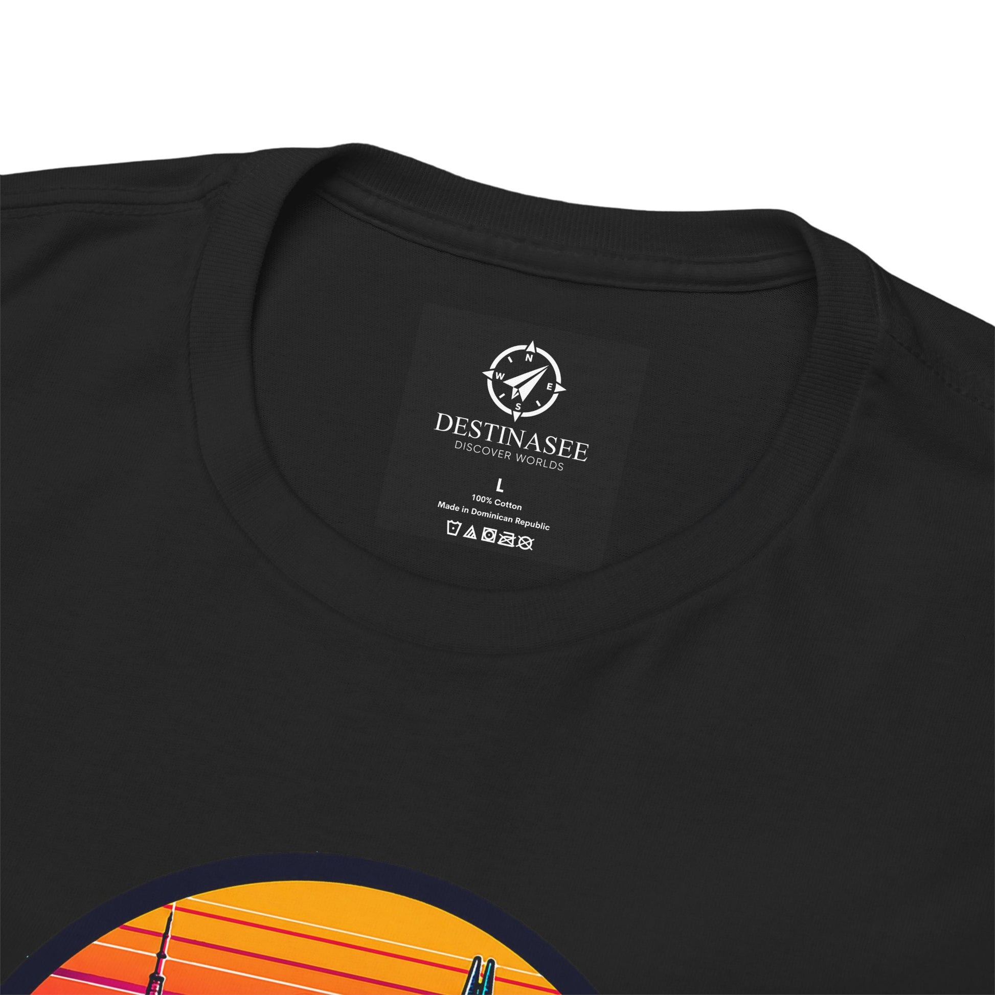 Black T-shirt close-up: neckline tag and partial colorful sunset skyline graphic