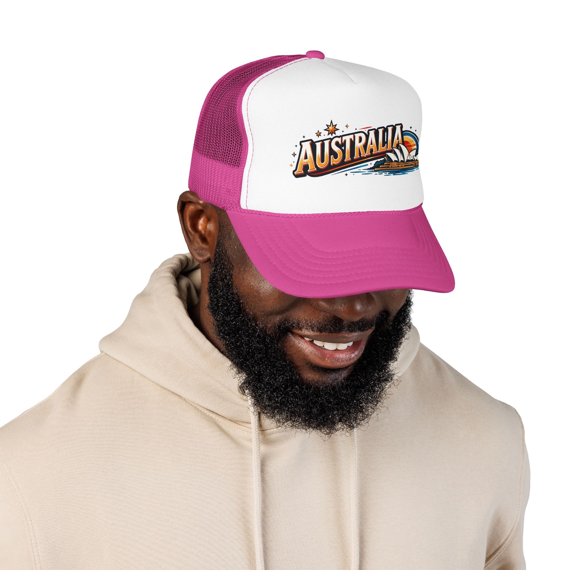 White and hot pink trucker cap with mesh back and embroidered AUSTRALIA logo, curved brim.