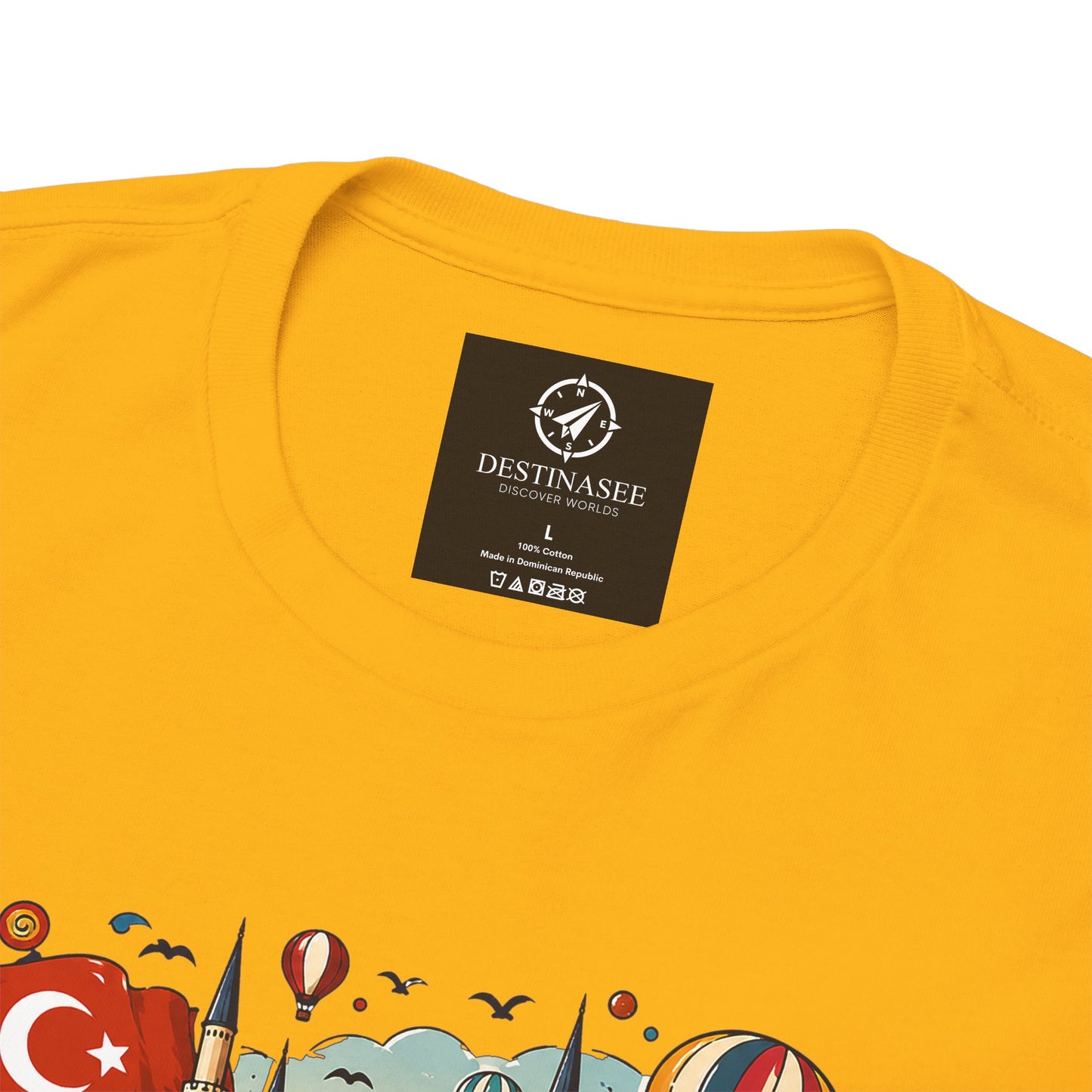 Yellow graphic tee with small chest logo label and partial colorful Turkey scene print
