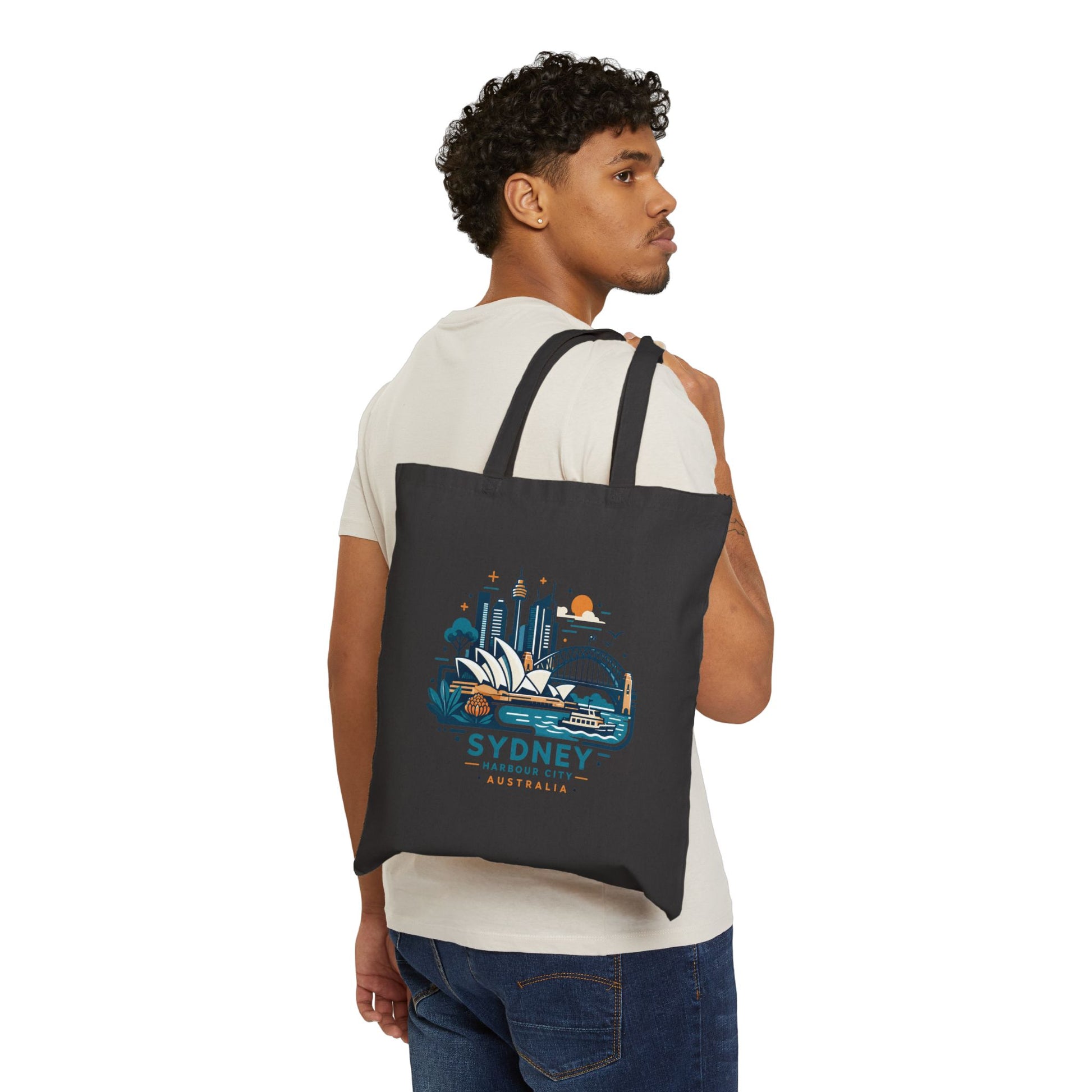 Black canvas tote bag with Sydney Harbour City graphic, worn over the shoulder