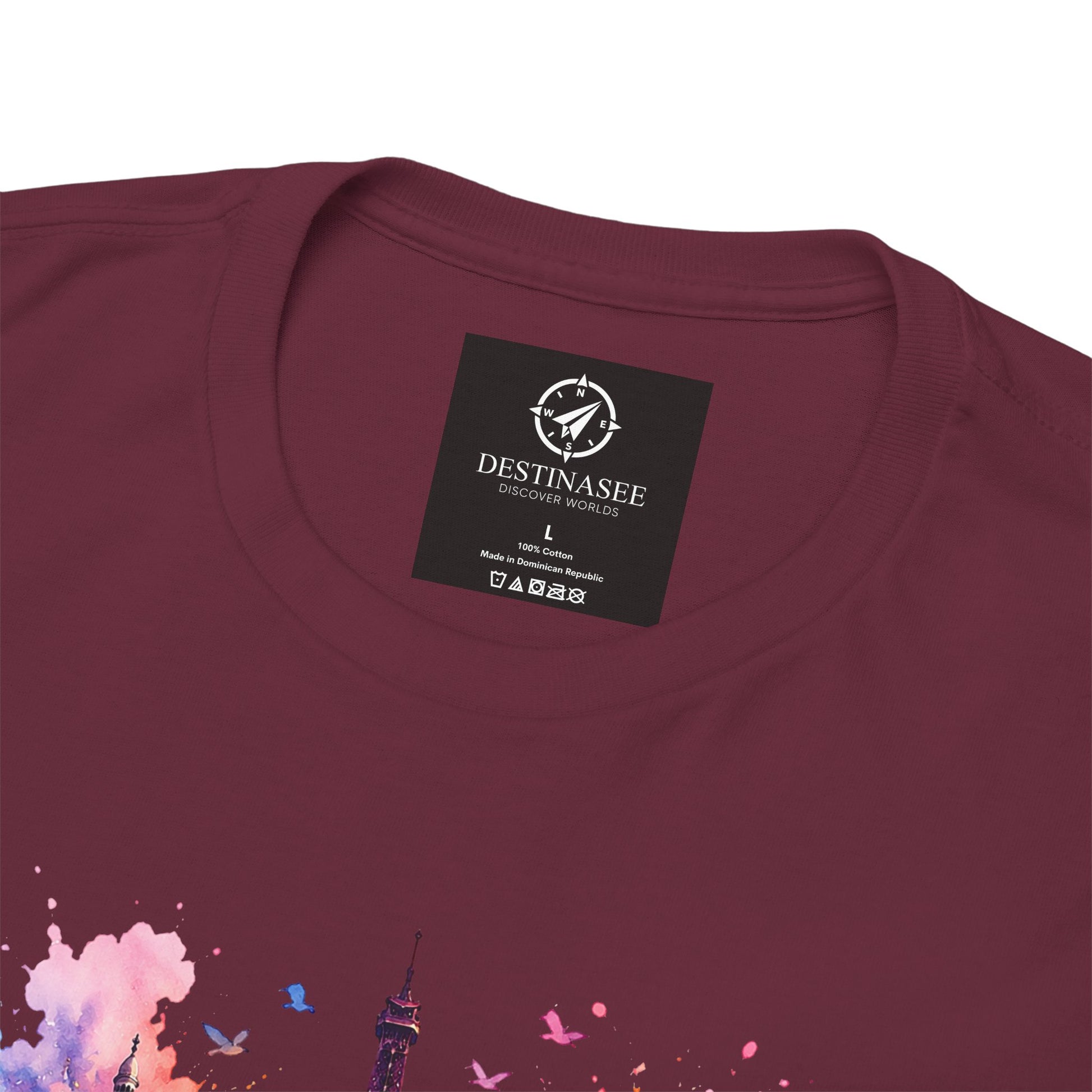 Maroon T-shirt back with small black brand label and partial floral Eiffel watercolor print