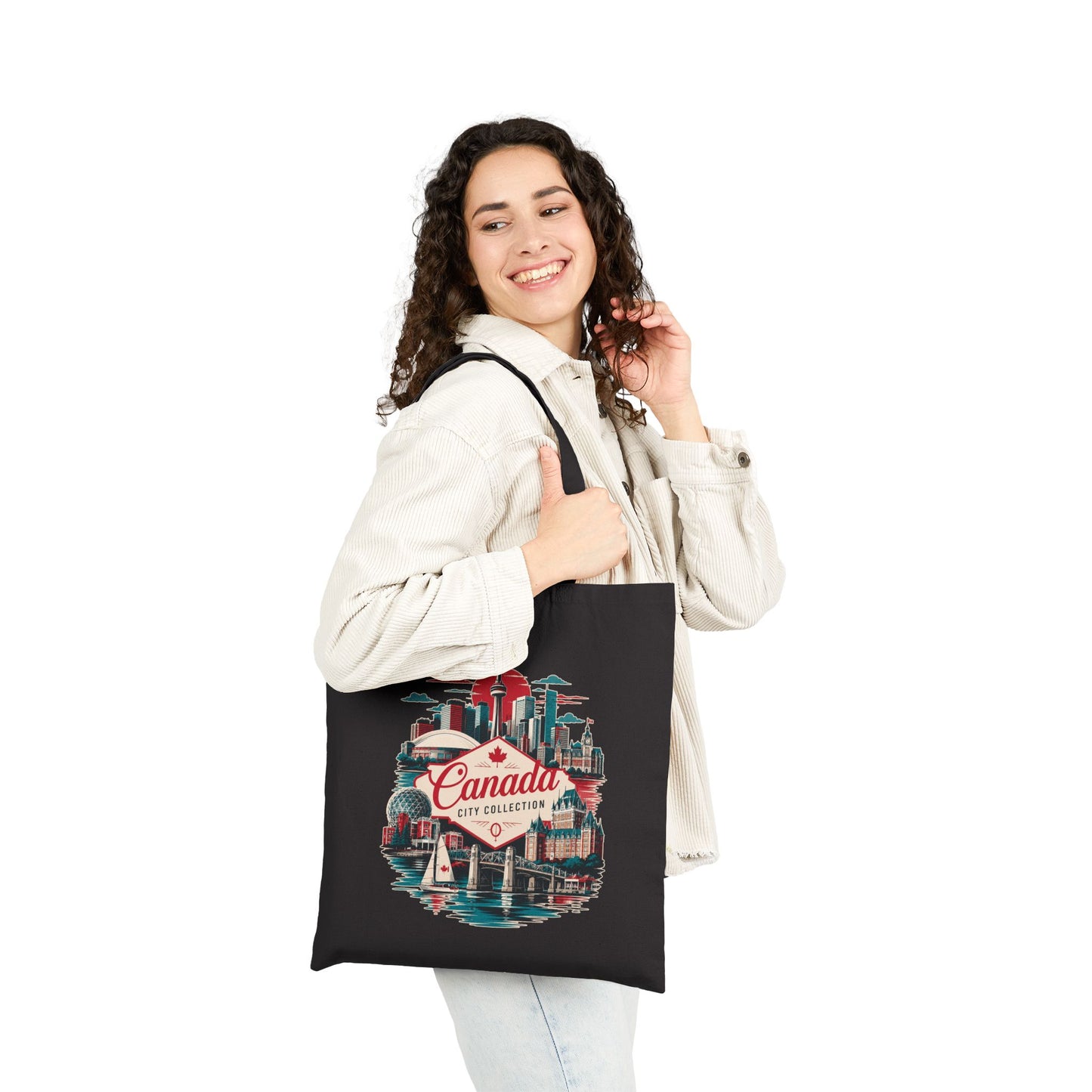 Black canvas tote bag, front view with Canada city skyline print and two handles.