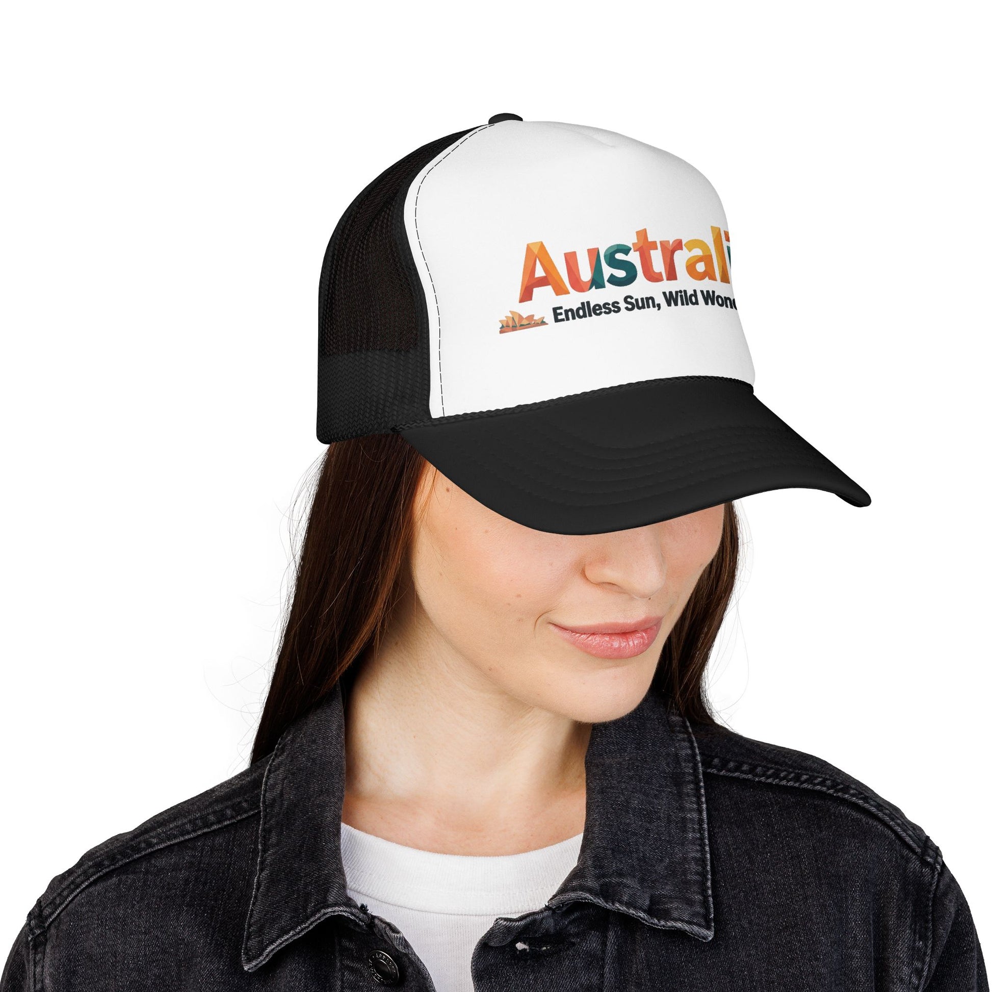Black-and-white trucker cap with orange Australia logo, worn by model with dark hair