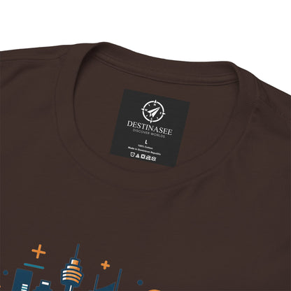 Dark brown crew-neck T-shirt close-up showing neckline label and partial cityscape graphic.
