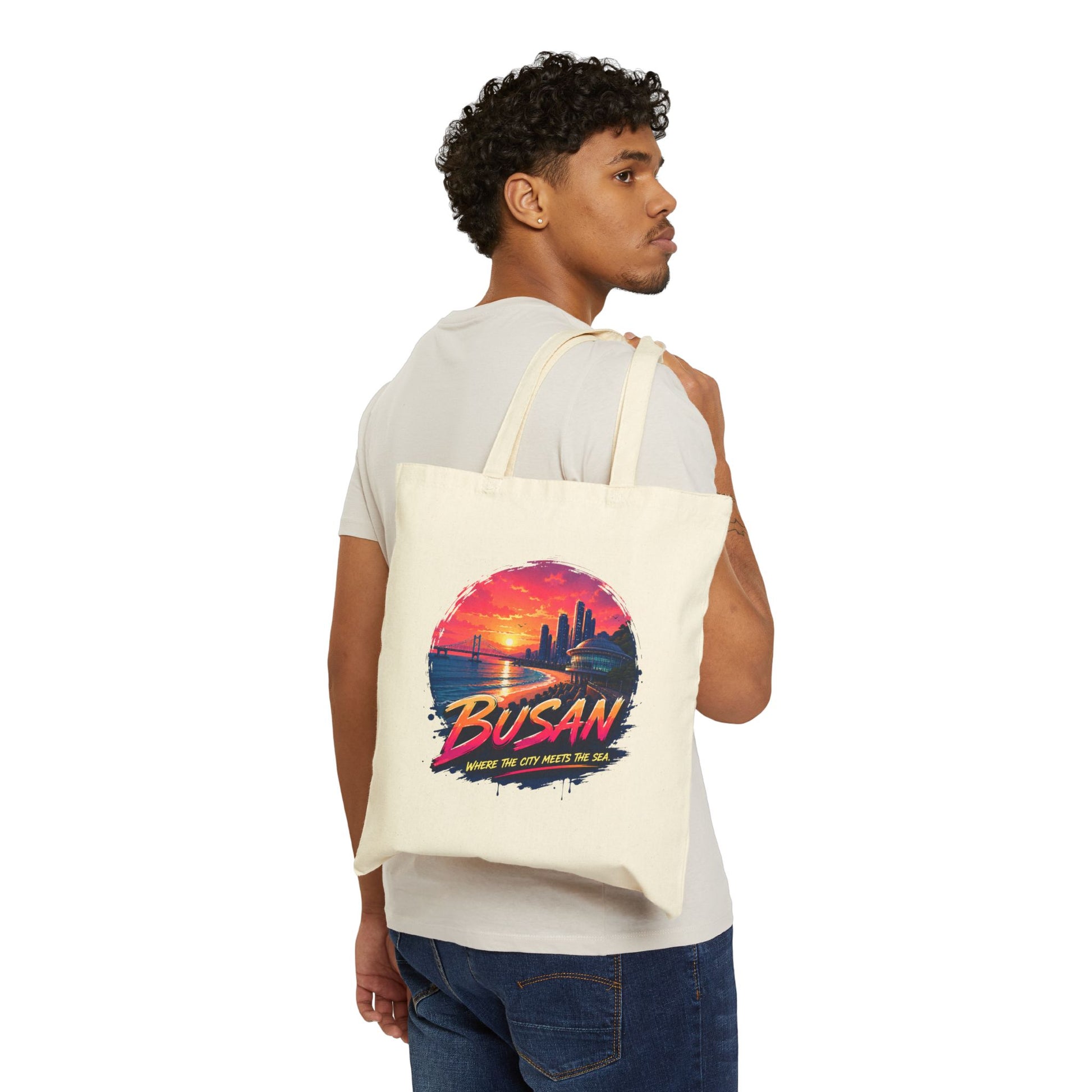 Natural canvas tote bag with Busan sunset front graphic on wearer
