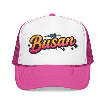 Pink and white trucker hat with “Busan” front logo and mesh side panels
