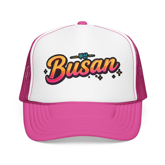 Pink and white trucker hat with “Busan” front logo and mesh side panels