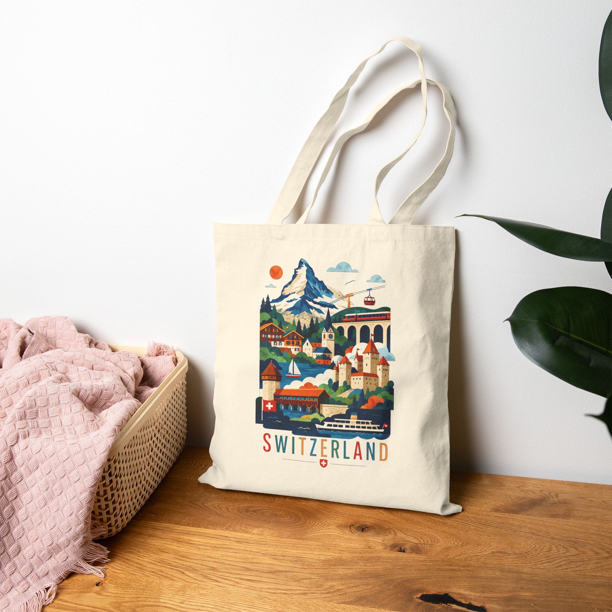 Natural canvas tote bag with colorful Switzerland scenic artwork and red “SWITZERLAND” text.