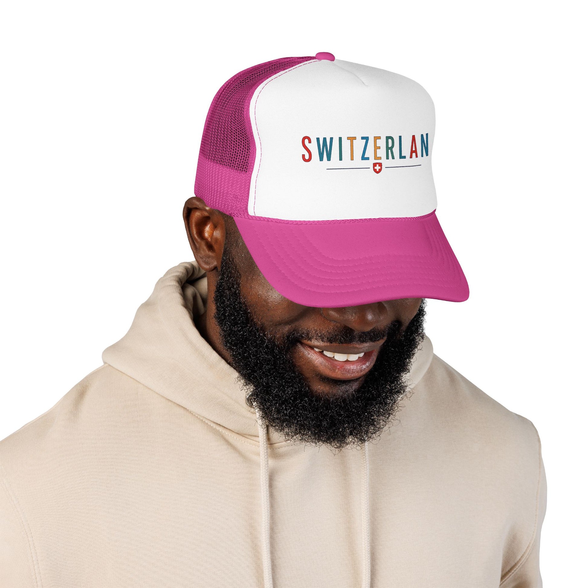 Magenta and white foam trucker cap with mesh back, worn forward, "SWITZERLAN" logo