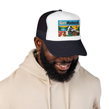 Black and white trucker hat with front alpine graphic patch; worn with a hoodie.