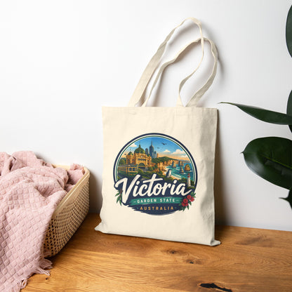Natural vintage travel tote bag with circular Victoria Australia logo graphic on front