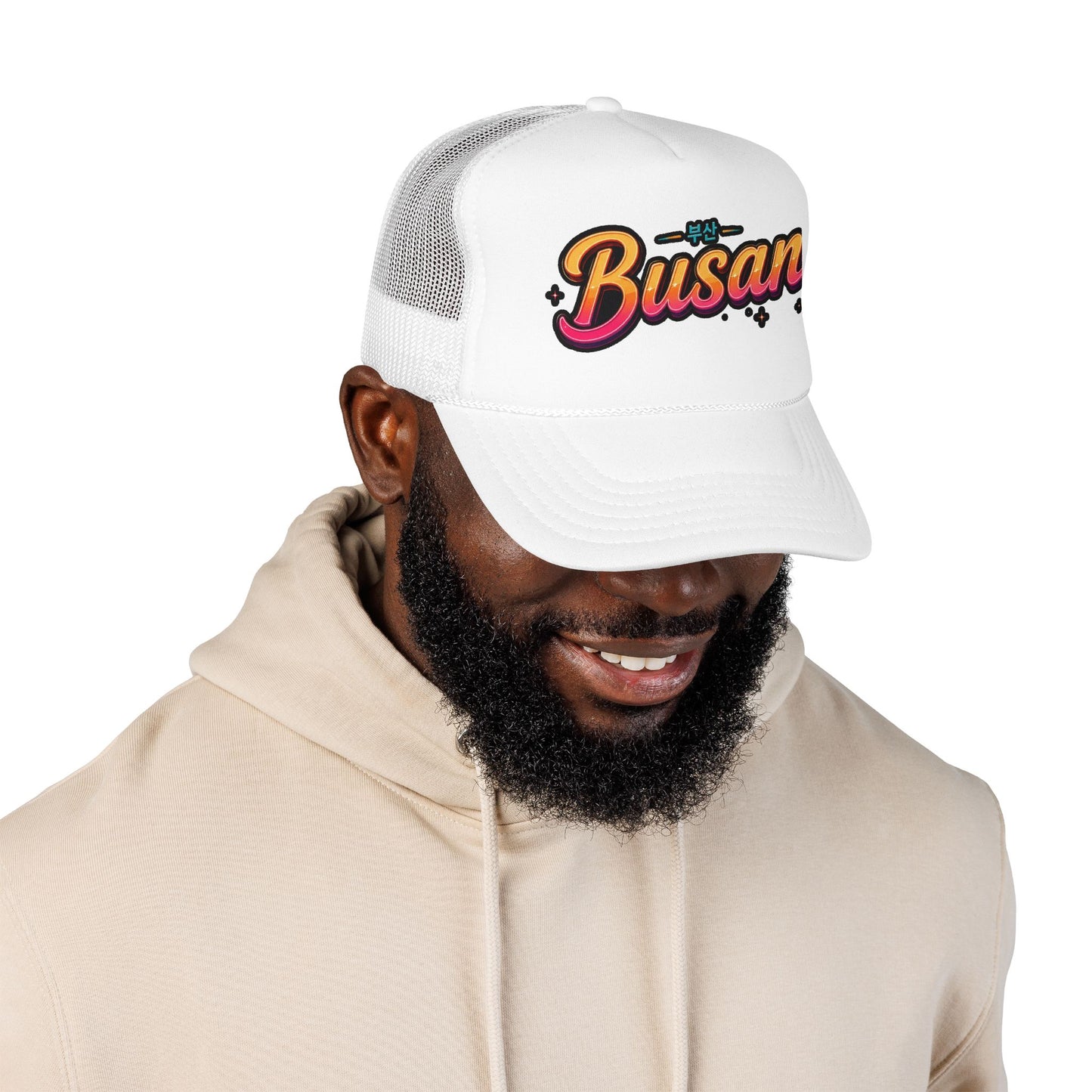 White mesh trucker hat on model, front “Busan” logo embroidery