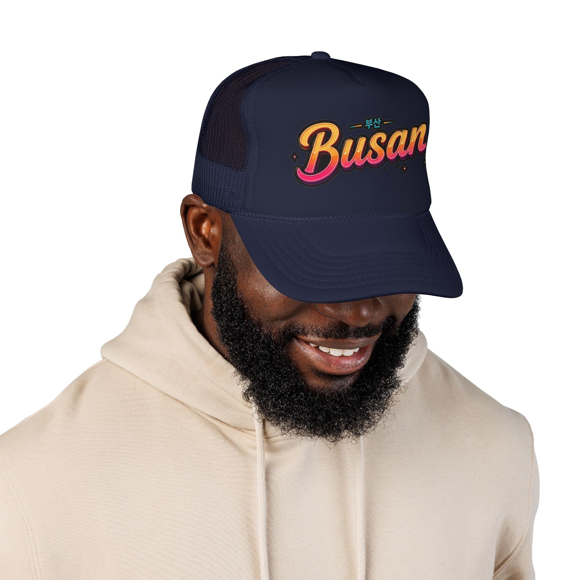 Navy trucker cap worn by man, embroidered Busan logo front