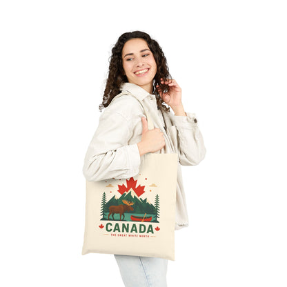 Natural canvas tote bag with Canada moose graphic on front, held up