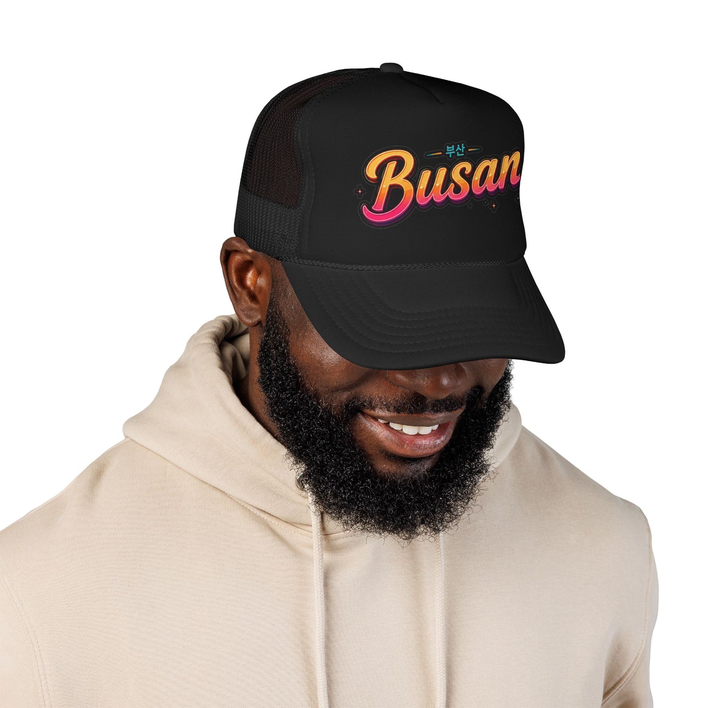 Black mesh trucker hat on model, front “Busan” logo embroidery