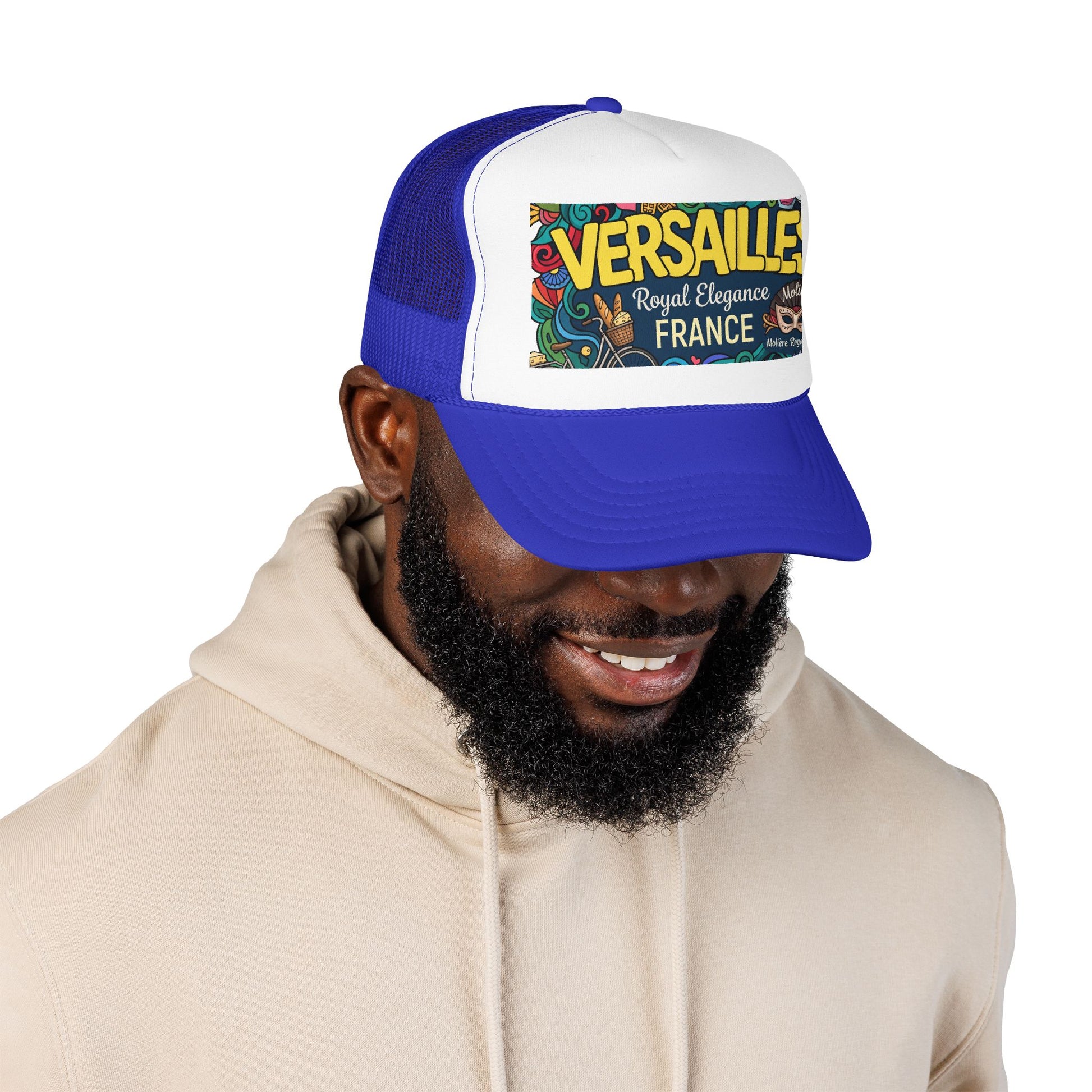 Royal blue and white trucker hat with mesh sides and 'Versailles France' front patch worn by model
