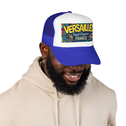 Royal blue and white trucker hat with mesh sides and 'Versailles France' front patch worn by model
