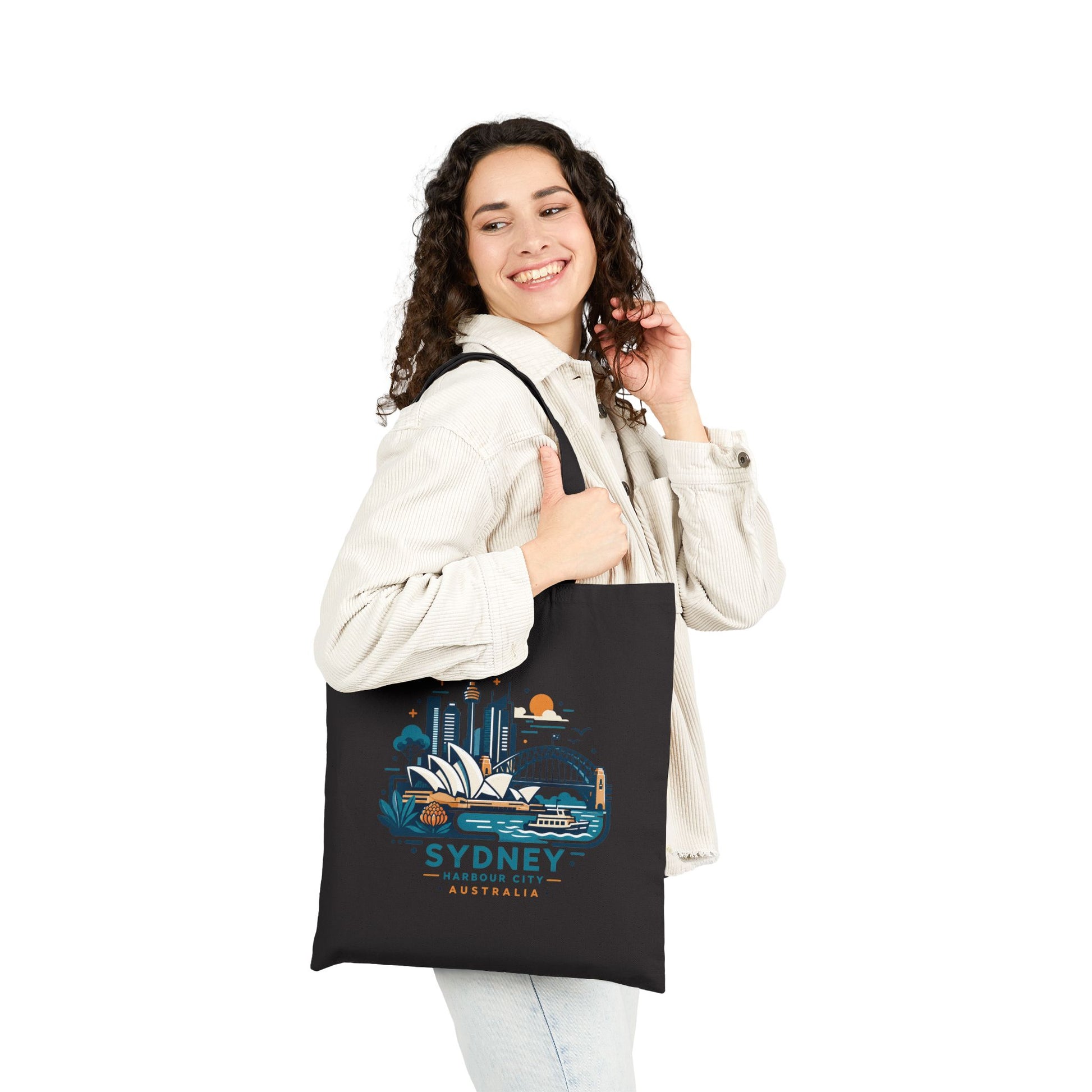 Black canvas tote bag with Sydney Harbour City graphic, worn on one shoulder