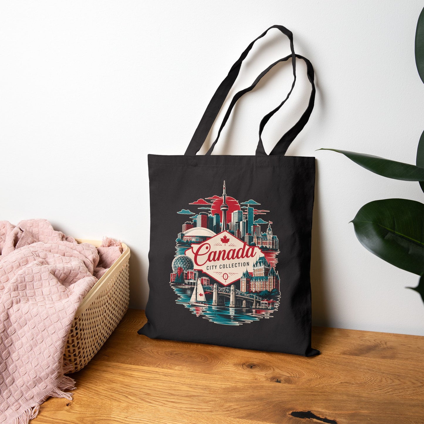Black tote bag with Canada skyline graphic and red “Canada” logo on front