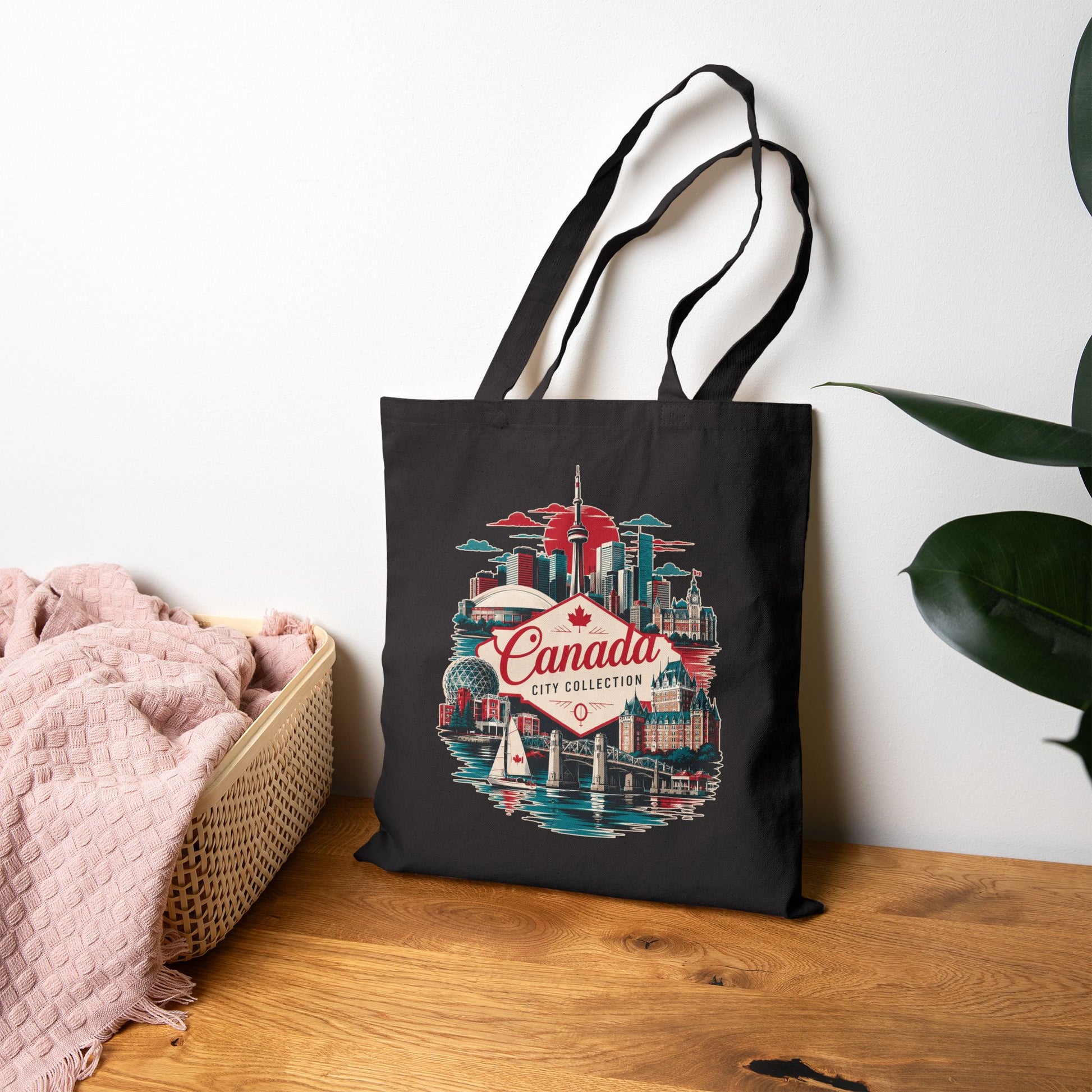 Black tote bag with Canada skyline graphic and red “Canada” logo on front