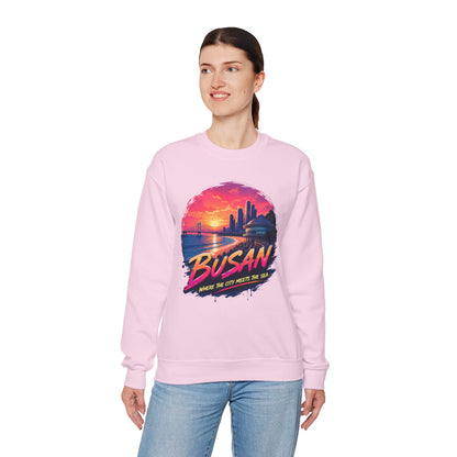 Light pink crewneck sweatshirt, front graphic of Busan sunset over sea and skyline