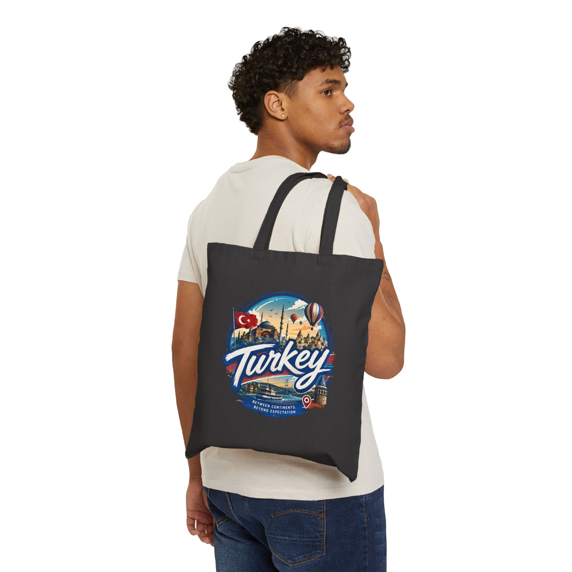Black canvas tote bag with Turkey graphic, worn over shoulder