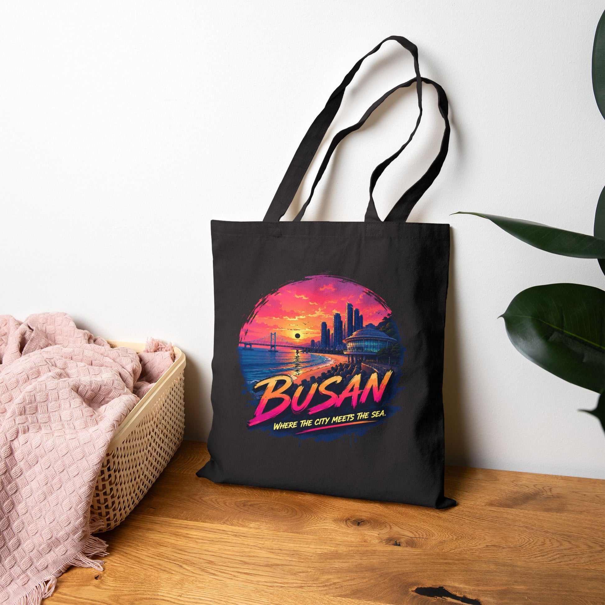 Black canvas tote bag with colorful Busan sunset print and top handles