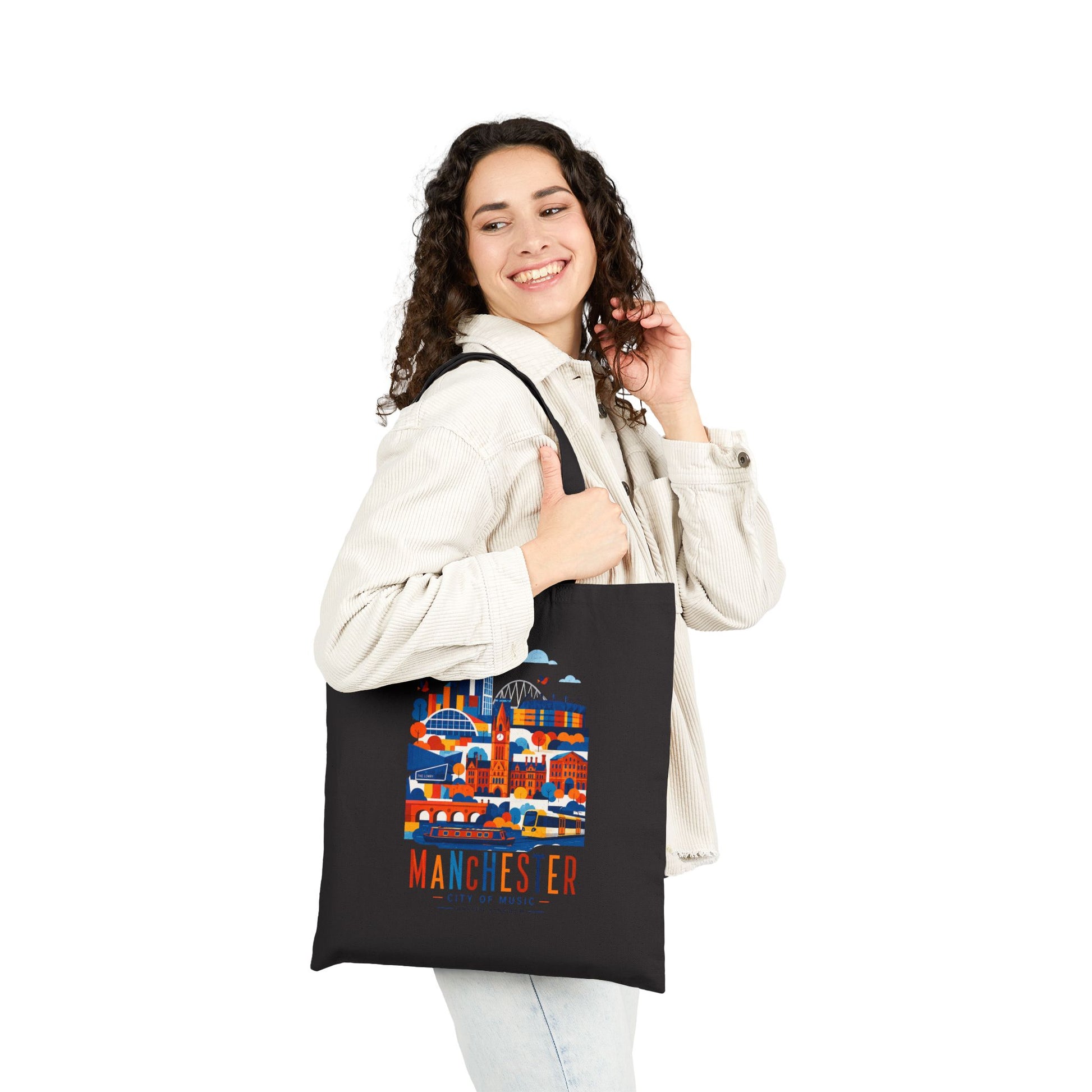 Black cotton tote bag with long handles and Manchester skyline graphic front.