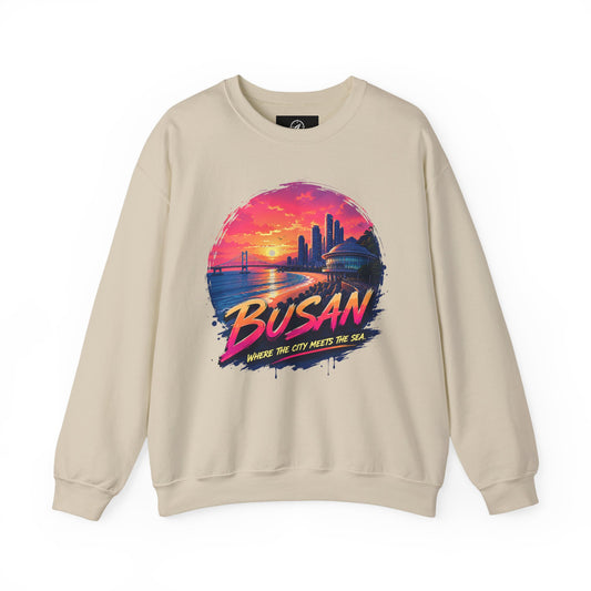 Sand-colored crewneck sweatshirt with Busan sunrise city graphic on the chest.
