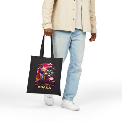 Black tote bag with Osaka skyline print, shown hanging from side while worn