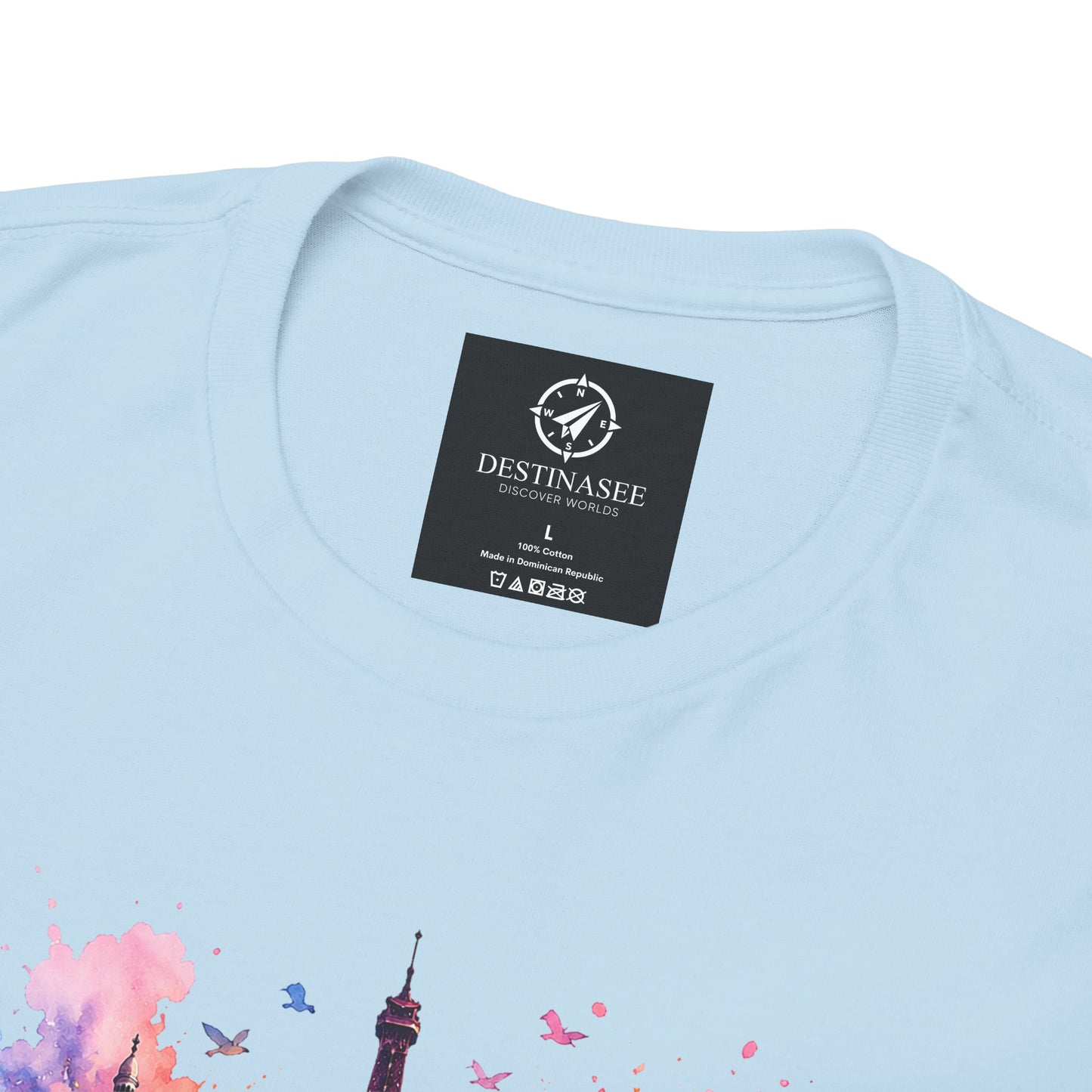 Light blue T-shirt back close-up with neck label and partial floral Eiffel Tower artwork