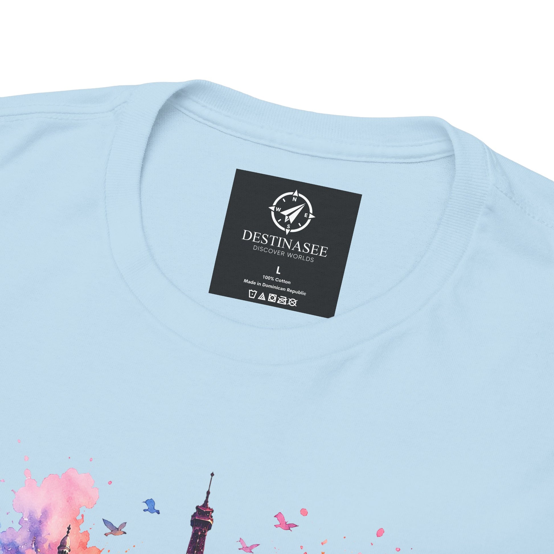 Light blue T-shirt back close-up with neck label and partial floral Eiffel Tower artwork