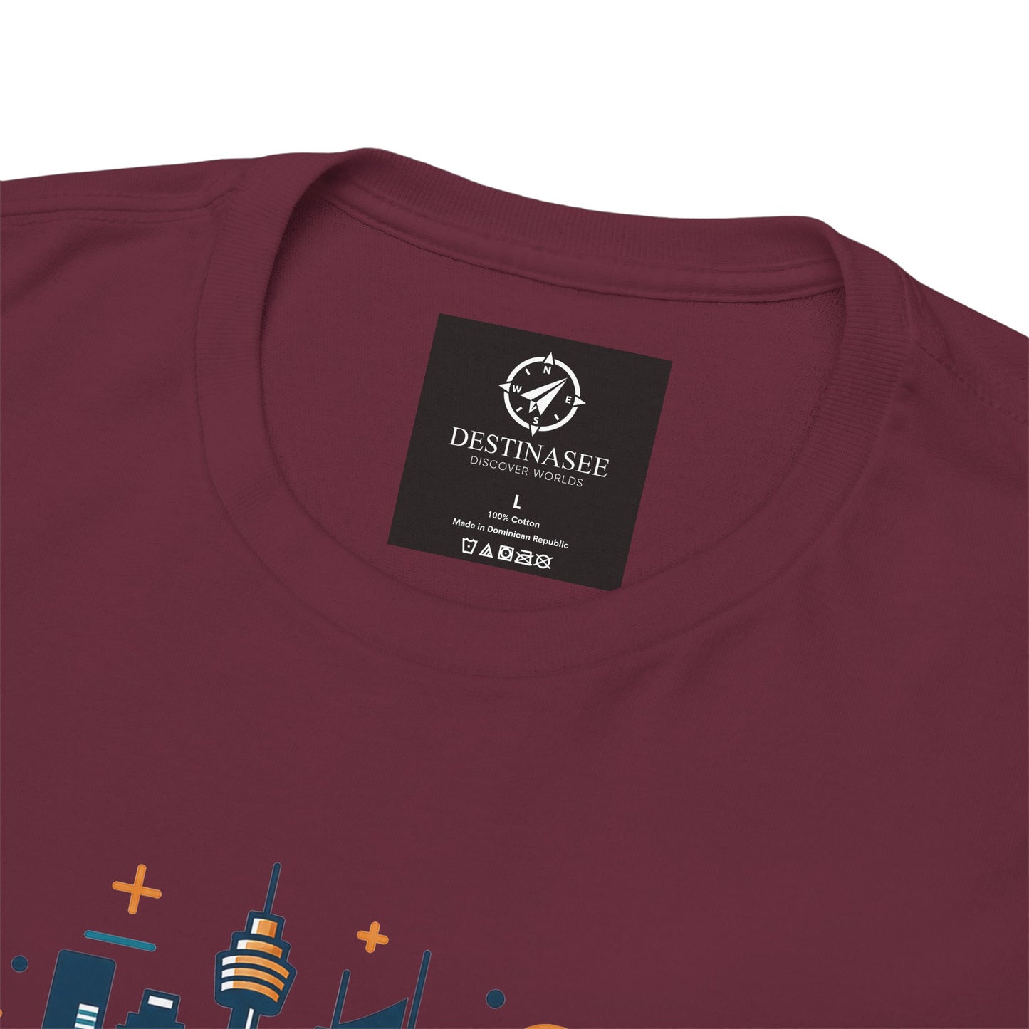 Maroon crew-neck T-shirt close-up showing neckline label and partial cityscape graphic.