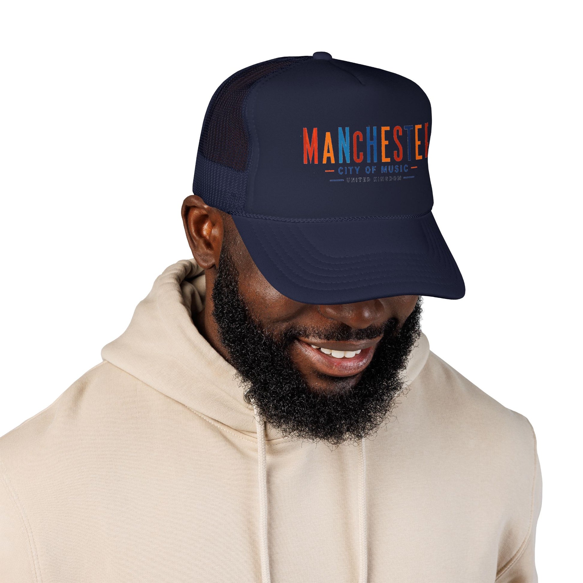 Navy trucker hat on model, Manchester City of Music logo visible on front.
