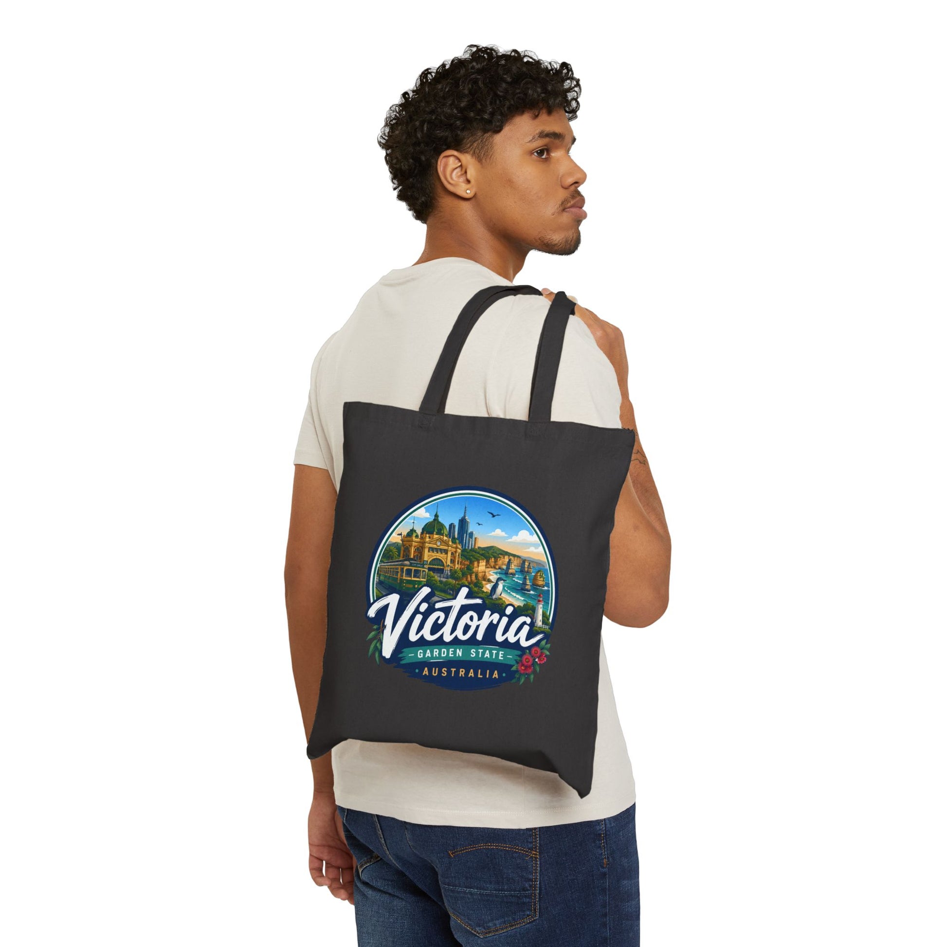Black vintage travel tote bag worn on shoulder, featuring circular Victoria Australia logo