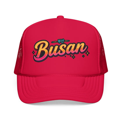 Red trucker hat with “Busan” front logo and mesh side panels