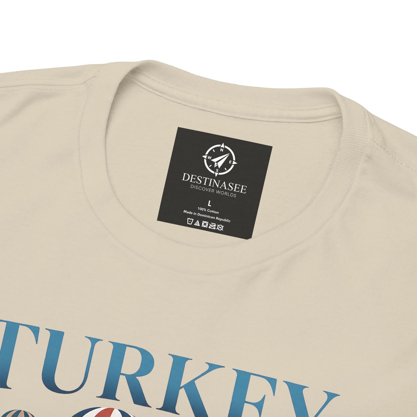 Natural T-shirt neckline with small brand label and partial blue Turkey graphic