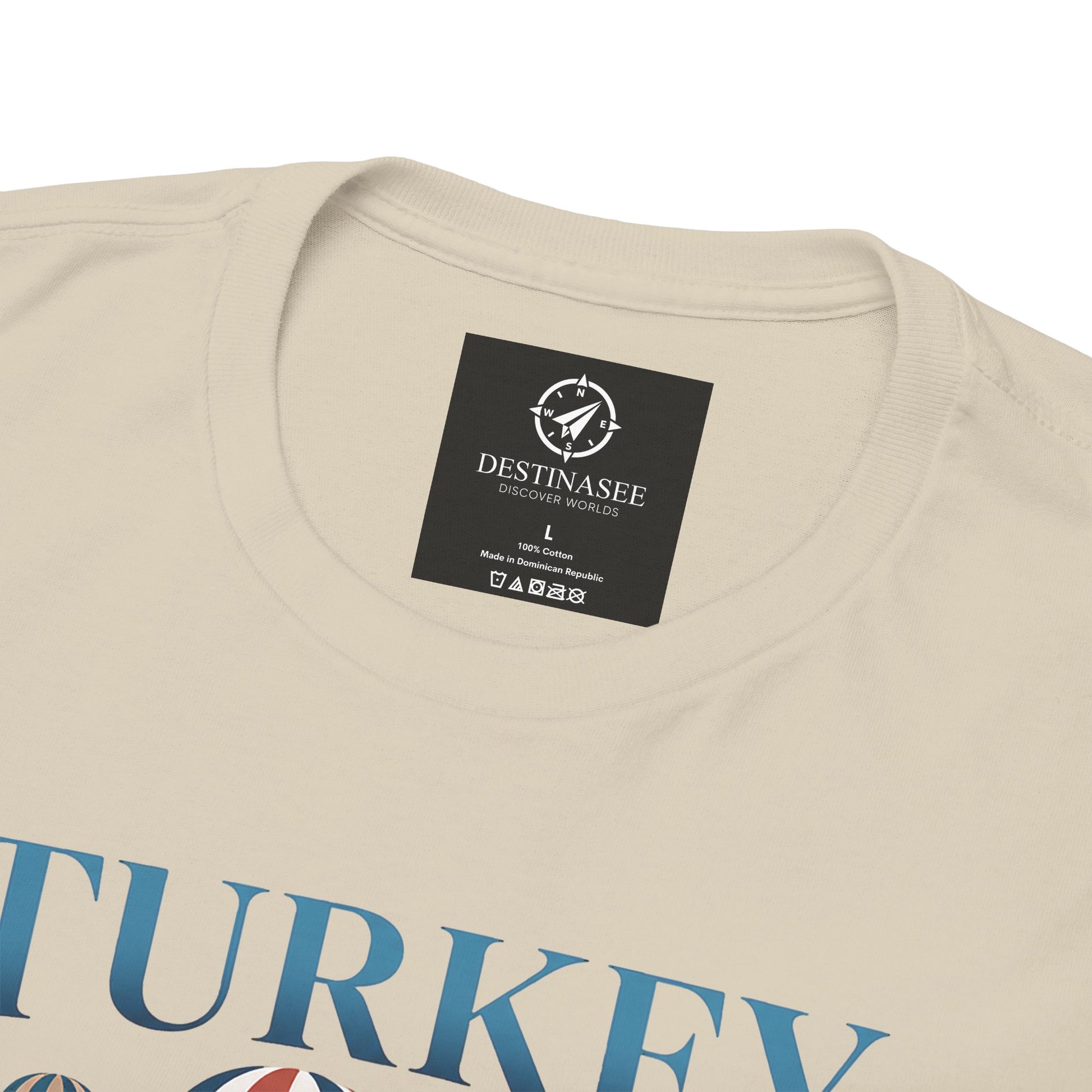 Natural T-shirt neckline with small brand label and partial blue Turkey graphic