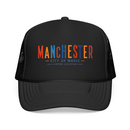 Black trucker hat with mesh sides and curved brim; Manchester City of Music logo in orange/blue.