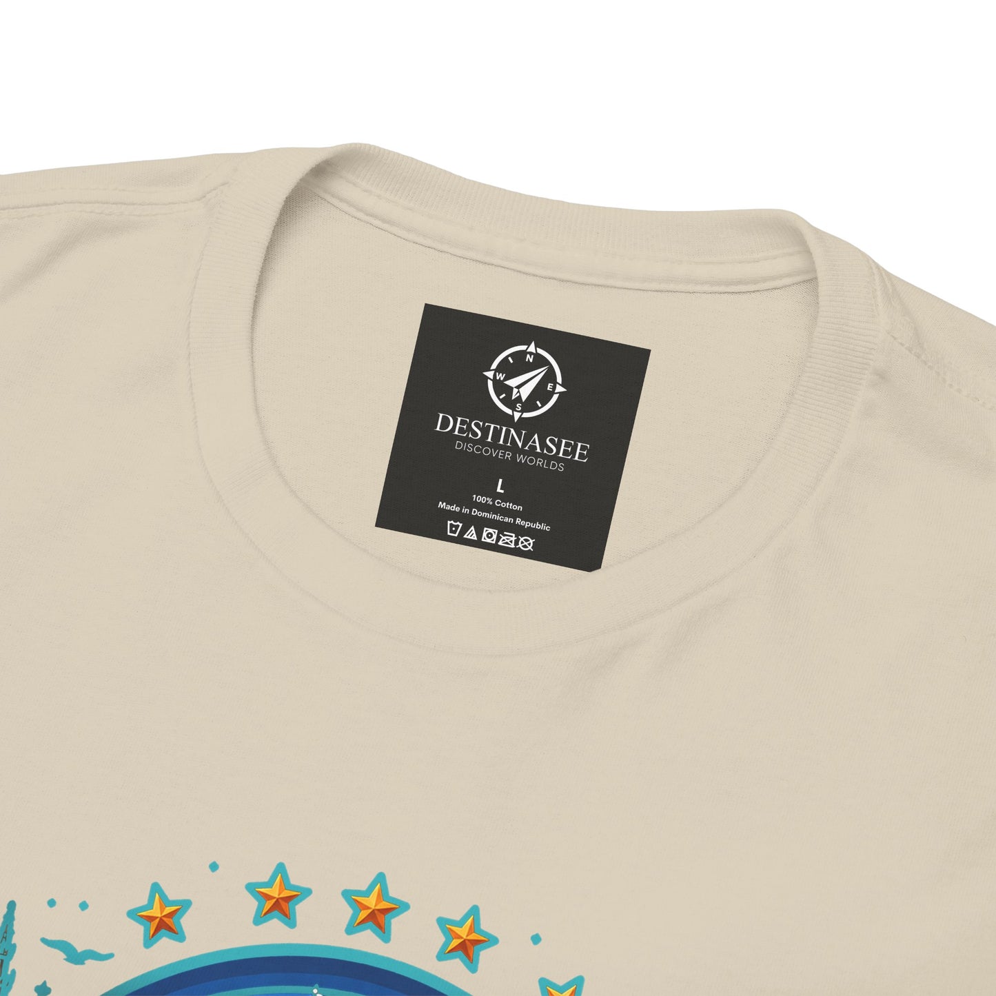 Light tan crew-neck T-shirt with small black neck label and partial colorful graphic print